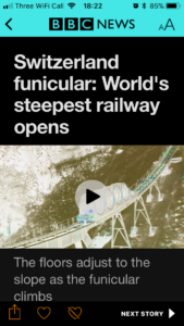 BBC news story with classic invert: the BBC branding colours have gone from red to cyan, and the photograph of the railway appears unnatural