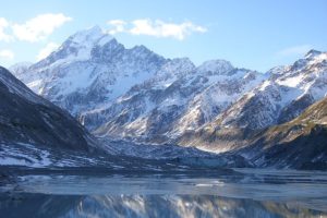 Aoraki/Mount Cook in winter, reflected in the waters of the lake in the foreground