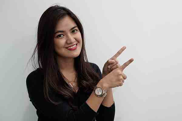 A smiling woman signs ‘Correct.’