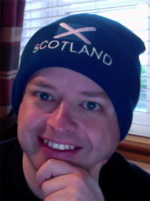 Graeme Coleman wearing a blue beanie with the Scottish flag.