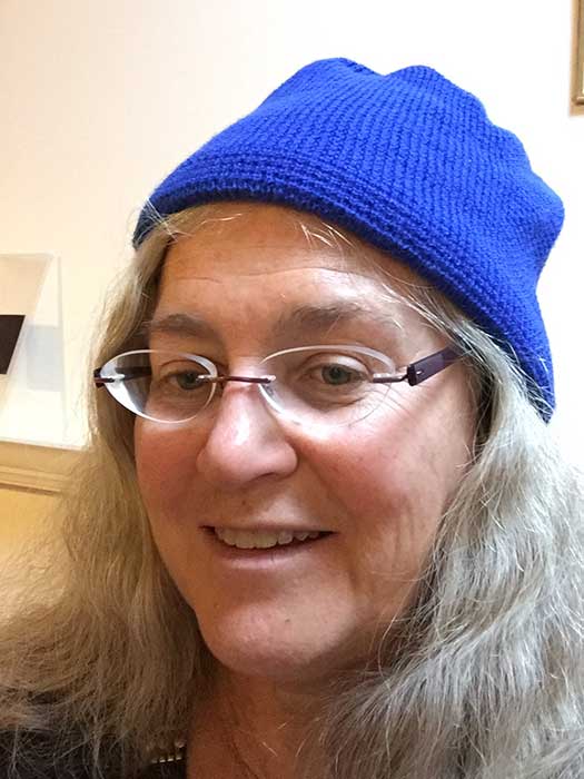 Jeanne Spellman wearing a blue beanie.