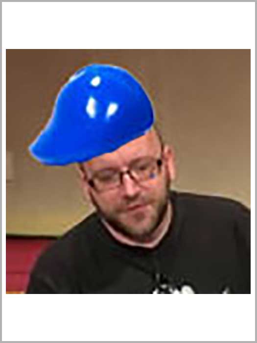 A tiny photo of Patrick Lauke with might be a plastic toy blue hat hastily pasted on top of his head.