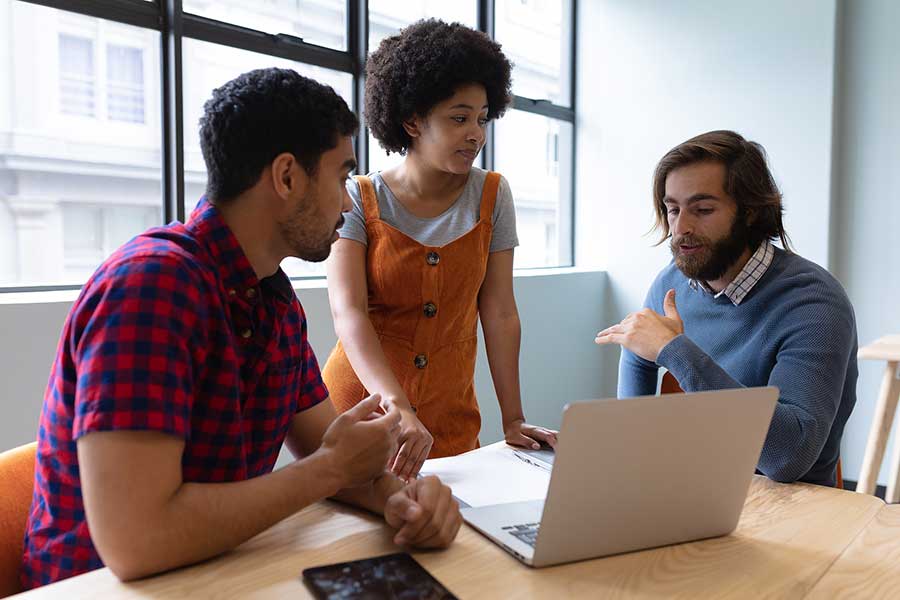 people gathered around a laptop