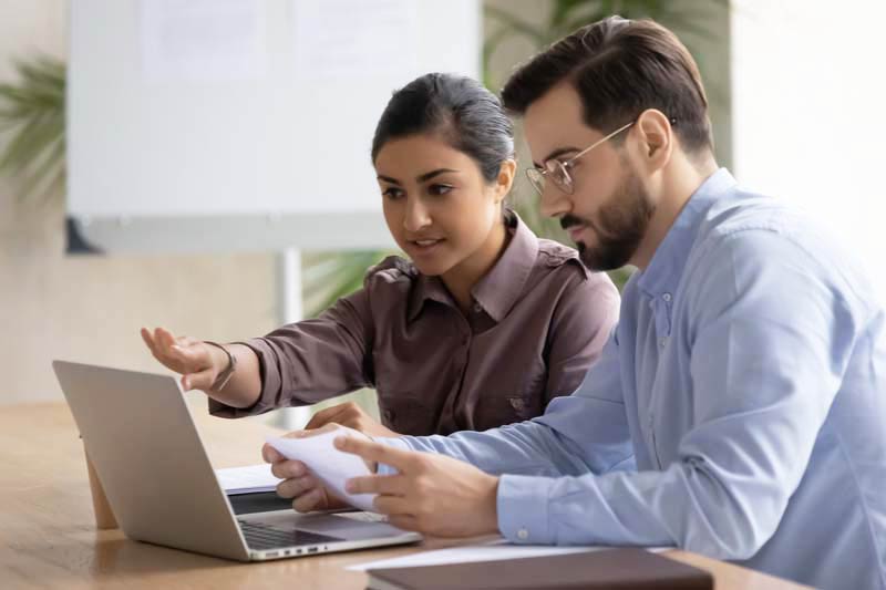 an accessibility engineer working with a female client on a computer