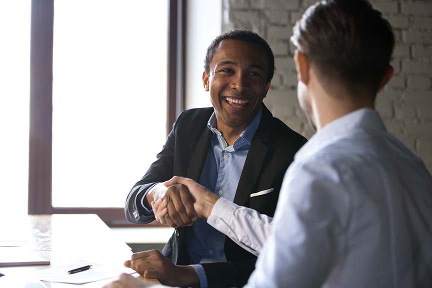 a TPGi accessibility sales executive shaking hands with a new customer